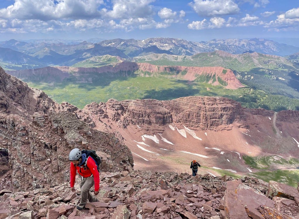 The final push up to North Maroon’s summit, red ridgelines of the Four Loop Pass visible behind us.